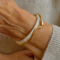 Elegant open bracelet with white enamel and gold – image 2
